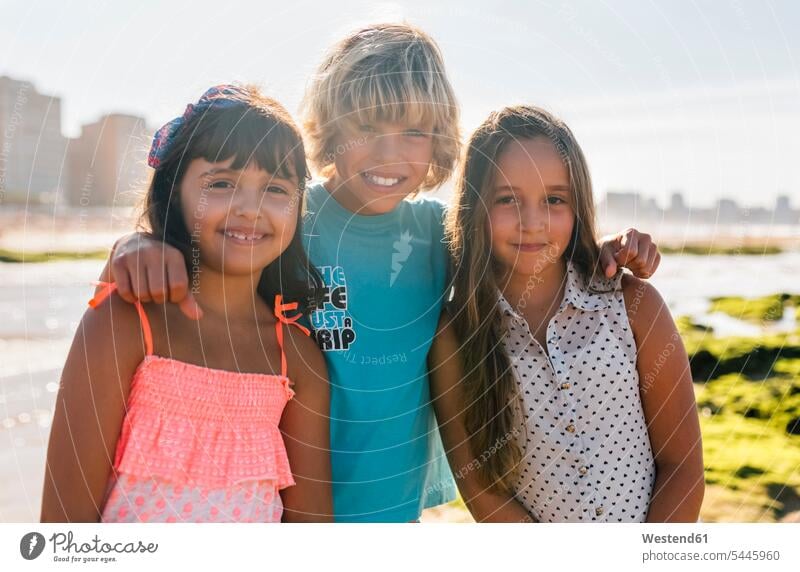 Portrait of three children on the beach friends girl females girls boy boys portrait portraits friendship kid kids people persons human being humans