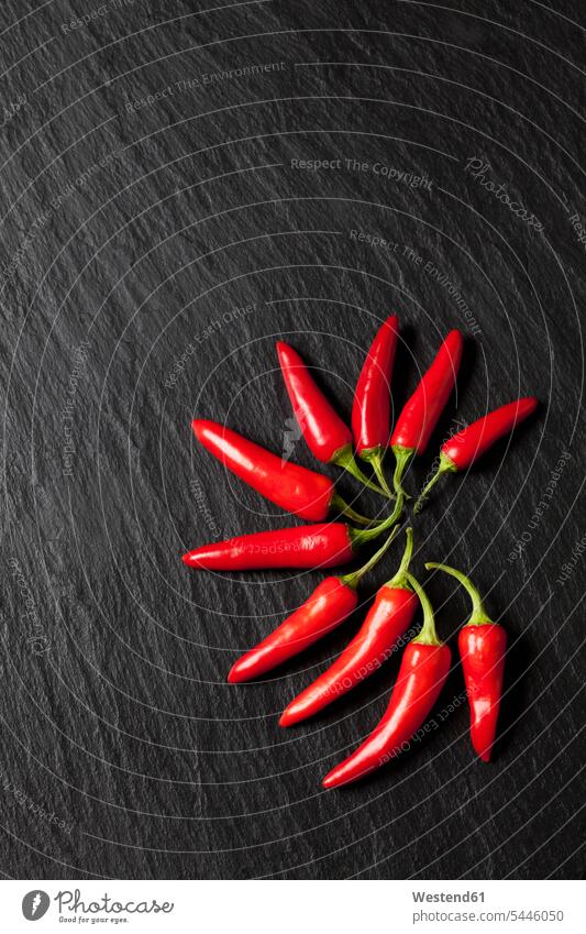 Red chili pods on slate food and drink Nutrition Alimentation Food and Drinks red Arrangement Positioning Positionings Arrangements arrangement grouping hot