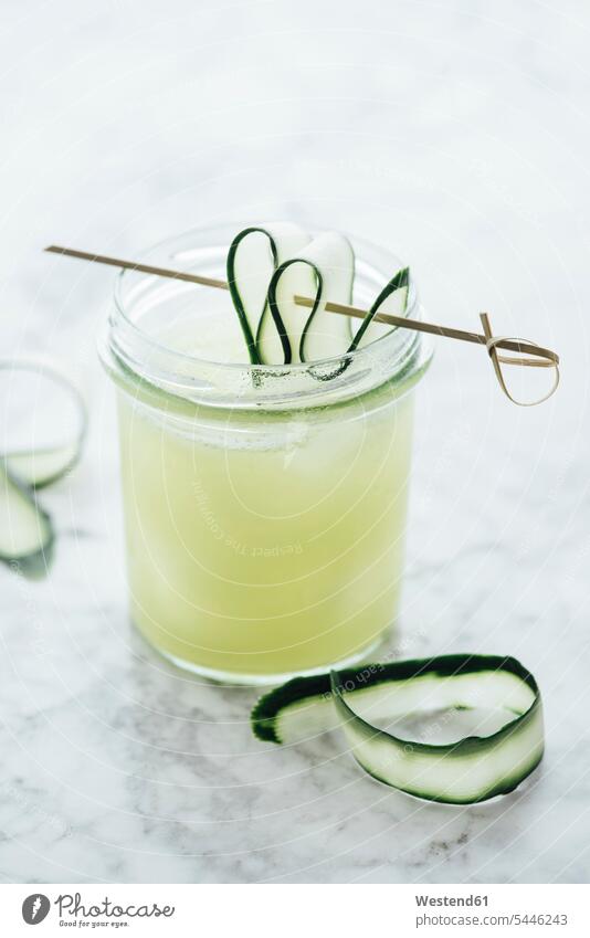 Glass of fresh cucumber juice with ice cubes ice-cooled iced cold Cold Weather Cold Temperature chilly skewered light background ice-cube ice-cubes Glasses