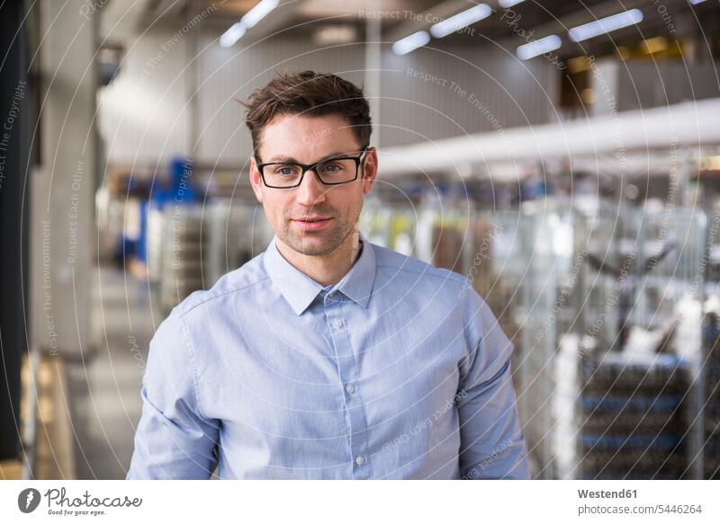 Portrait of confident businessman in factory shop floor factories men males Businessman Business man Businessmen Business men Adults grown-ups grownups adult