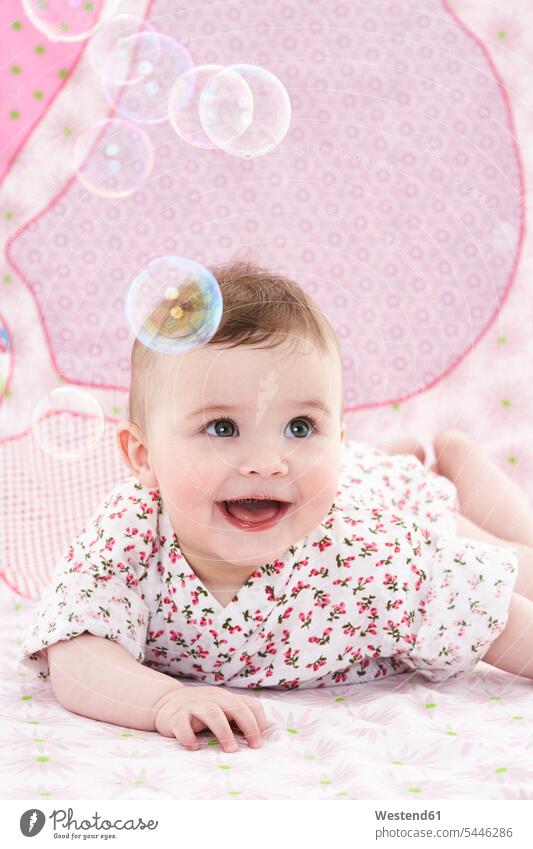 Portrait of amazed baby girl watching soap bubbles baby girls female infants nurselings babies portrait portraits people persons human being humans human beings