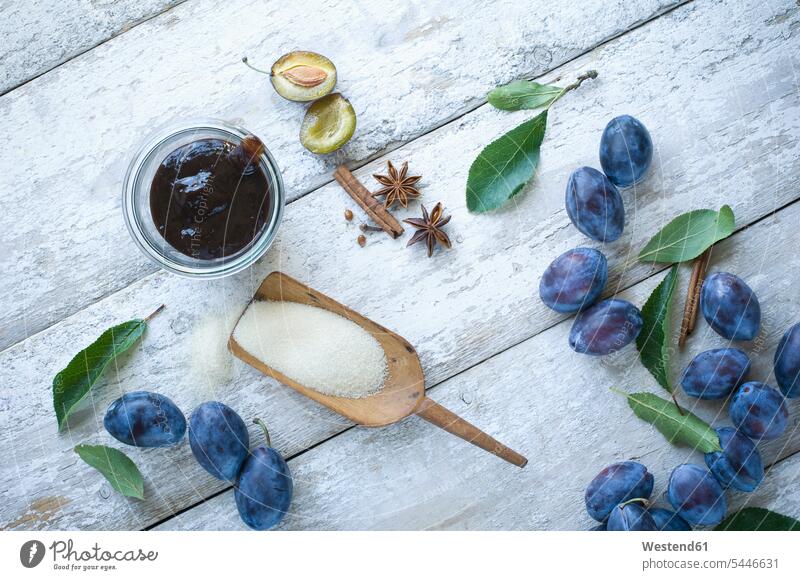 Preserving jar of plum jam and ingredients on wood Sugar spice spices healthy eating nutrition Fruit Fruits light background boiled cooked Star Anise star-anise