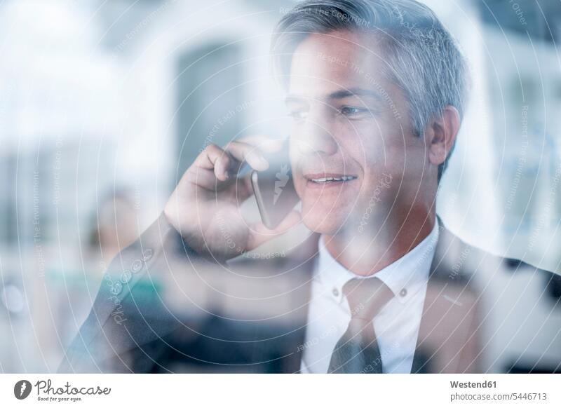 Businessman in office talking on the phone Success successful Business man Businessmen Business men Office Offices Smartphone iPhone Smartphones professional