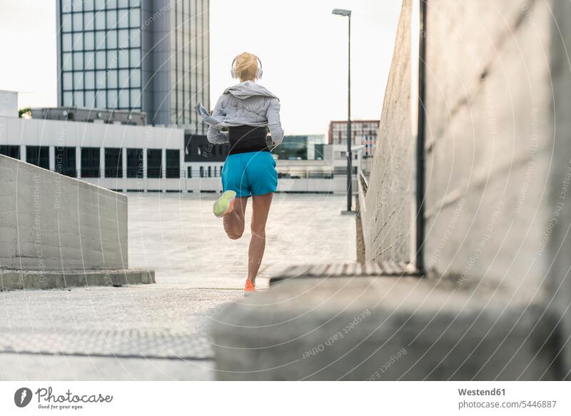 Woman running in the city Jogging woman females women fitness sport sports Adults grown-ups grownups adult people persons human being humans human beings