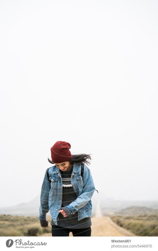 Spain, Navarra, Bardenas Reales, smiling young woman walking in nature park females women Adults grown-ups grownups adult people persons human being humans