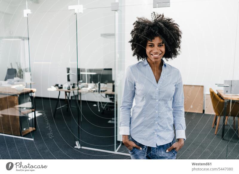 Portrait of smiling young woman in office smile portrait portraits females women standing Adults grown-ups grownups adult people persons human being humans