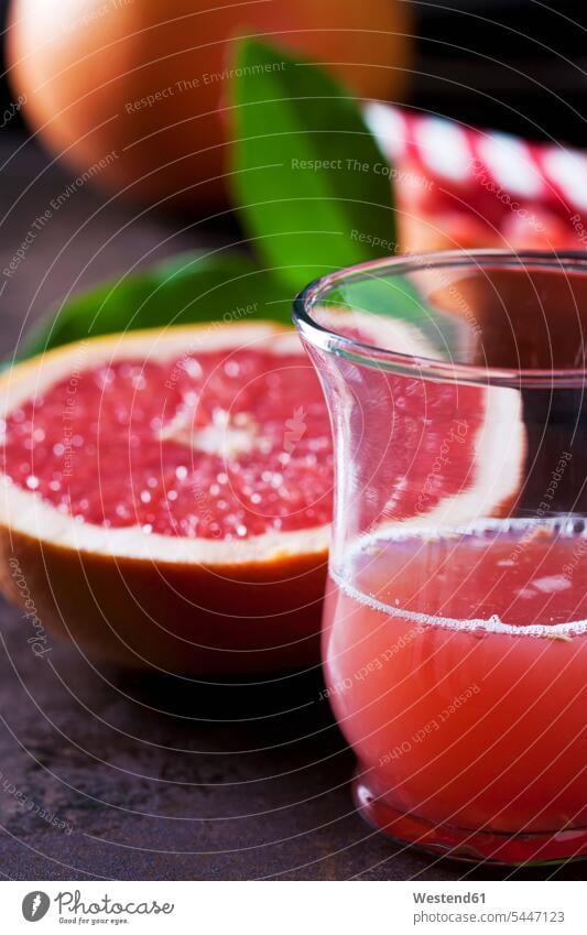 Glass of red grapefruit juice Drinking Glasses healthy eating nutrition gleaming half halves halved sliced vitamin C vitamine C knife Table Knife Table Knives