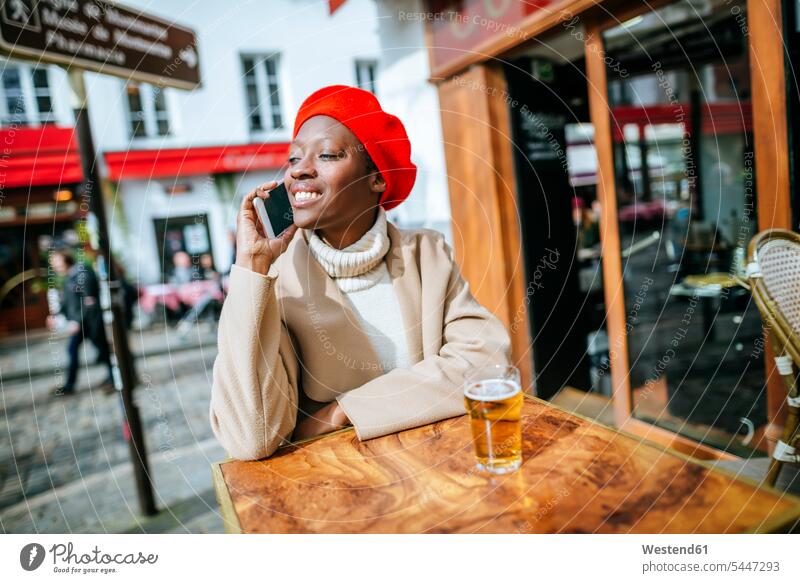 Young woman in Paris sitting in cafe and talking on the phone call telephoning On The Telephone calling smiling smile females women Seated Smartphone iPhone