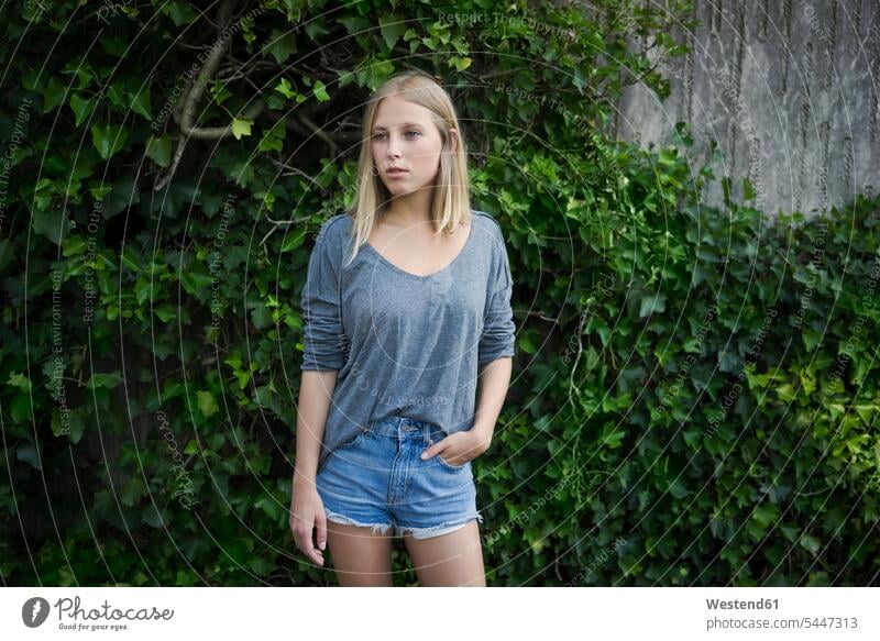 Portrait of blond young woman wearing jeans shorts portrait portraits blond hair blonde hair females women people persons human being humans human beings