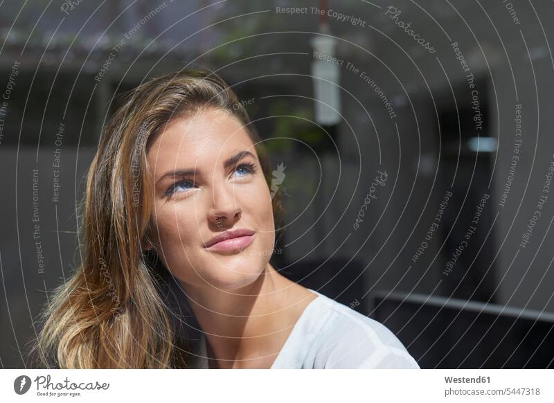 Smiling young woman looking out of window windows smiling smile young women thinking inventive Resourceful Inspirational Imaginative inventiveness ingenuity