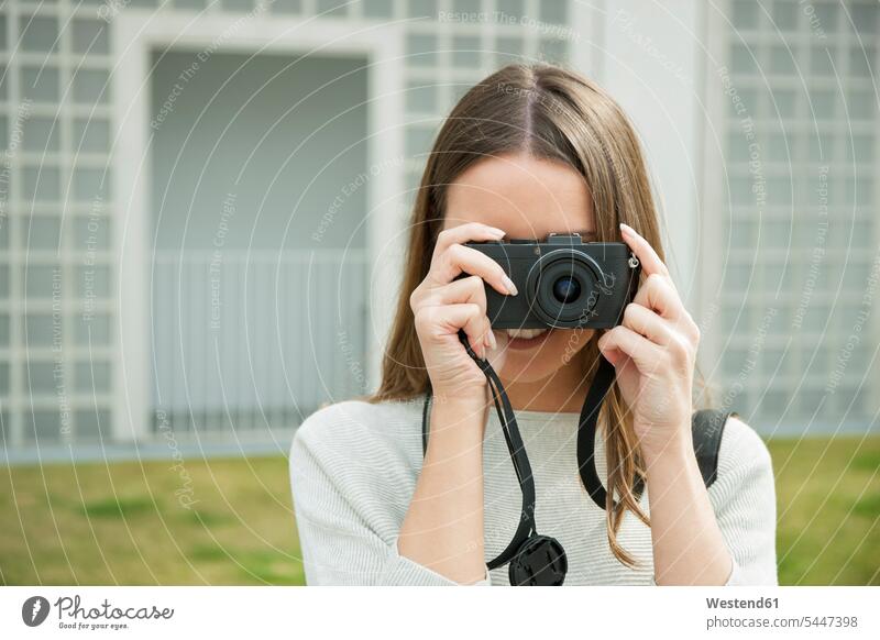 Young woman looking through camera females women cameras photographing analogue Adults grown-ups grownups adult people persons human being humans human beings