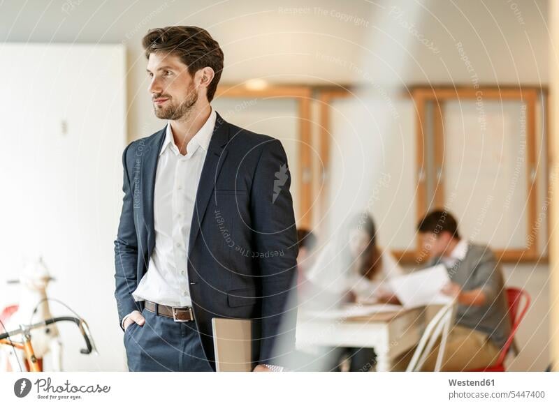 Businessman holding tablet with a meeting in background digitizer Tablet Computer Tablet PC Tablet Computers iPad Digital Tablet digital tablets office offices