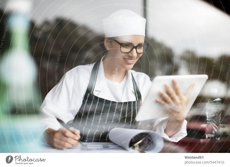 Smiling woman in workwear with clipboard and tablet at the window digitizer Tablet Computer Tablet PC Tablet Computers iPad Digital Tablet digital tablets