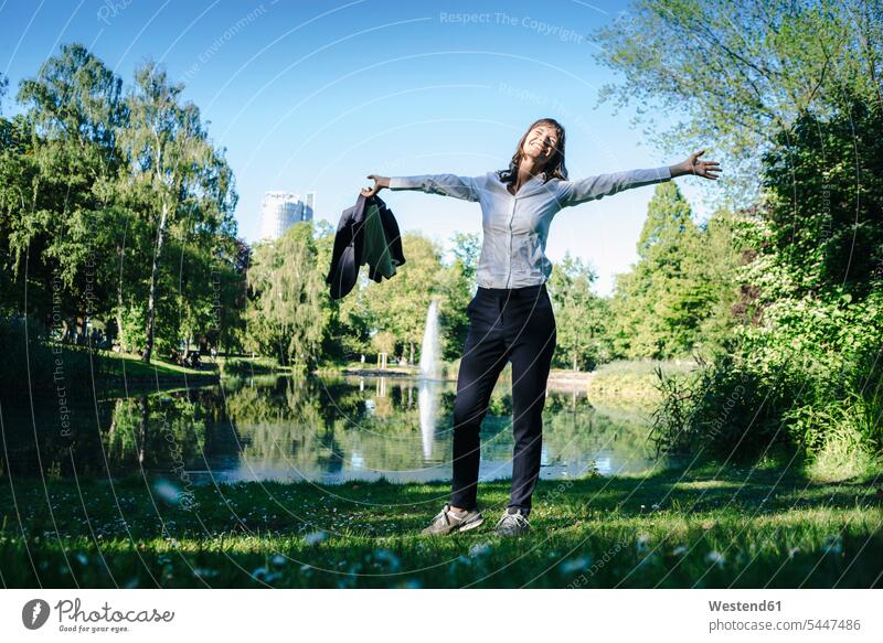 Businesswoman relaxing in the park businesswoman businesswomen business woman business women carefree enjoying indulgence enjoyment savoring indulging Stroll