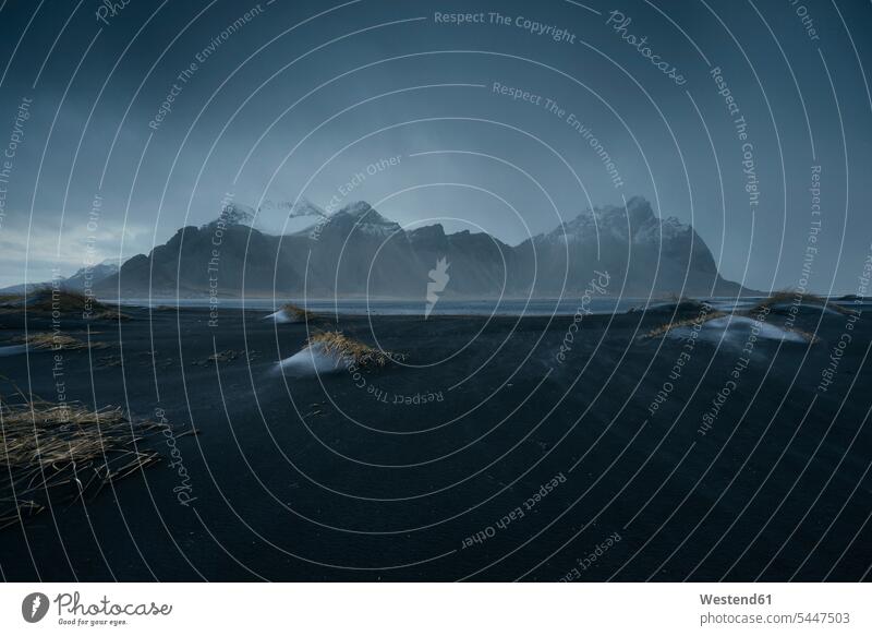 Iceland, Vestrahorn Mountain under a storm cloud clouds storms dark cloud dark clouds sea ocean beach beaches Travel Black Sand landscape landscapes scenery