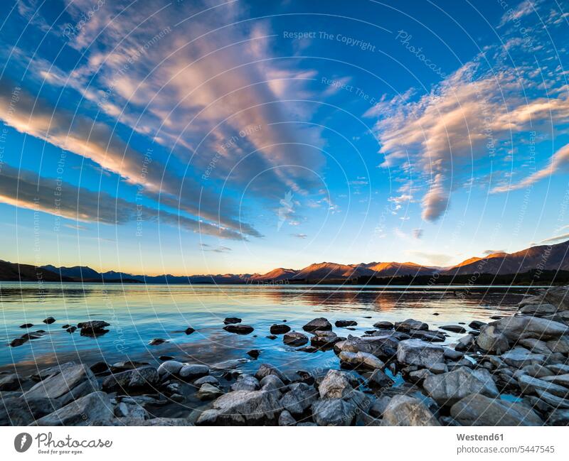 New Zealand, South Island, Canterbury Region, Lake Tekapo at sunset evening in the evening water reflection water reflections cloudy cloudiness clouds Solitude