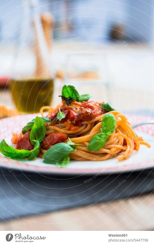 Spaghetti with cherry tomatoes and basil on a plate Plate dish dishes Plates prepared garnished Italian Food Italian cuisine ready to eat ready-to-eat Basils