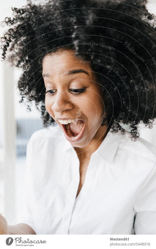 Young woman looking at her digital tablet for good news business business world business life cheering jubilate rejoicing rejoice exultation jubilating carefree