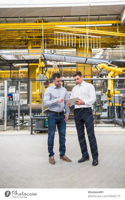 Two men with tablet talking in factory shop floor digitizer Tablet Computer Tablet PC Tablet Computers iPad Digital Tablet digital tablets man males colleagues