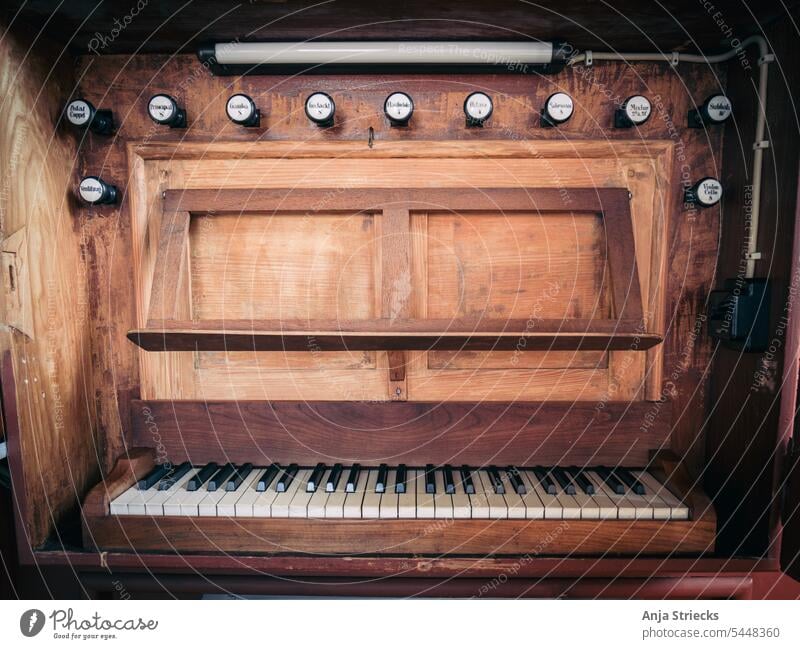 Organ in a small village church fumble Keyboard Keyboard instrument Music Detail view organ Wood register music stand Old dignified Interior shot Sound