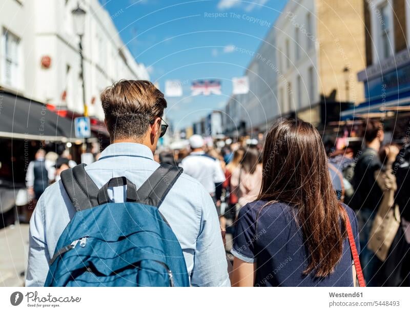 UK, London, Portobello Road, back view of couple on shopping spree twosomes partnership couples people persons human being humans human beings Market Markets