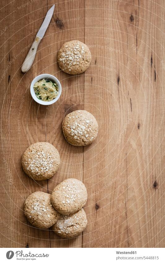 Homemade oat rolls with compound butter herbs Butter wooden copy space homemade home made home-made Dipping Bowl baked Baked Food nobody overhead view