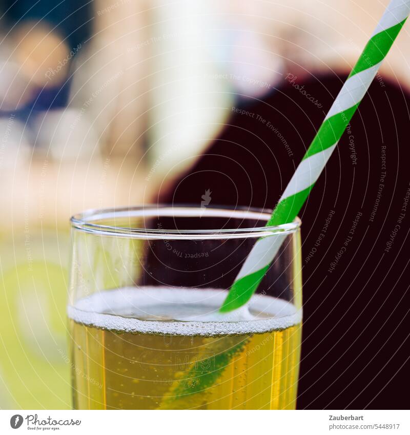 Drinking straw, green and white striped, stuck in glass with apple spritzer Straw Green White Beverage Summer Spritzer Apple spritzer Refreshment refreshingly