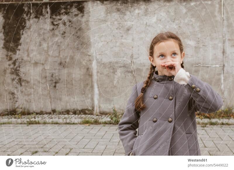 Portrait of little girl with braids wearing grey coat portrait portraits females girls Coat Coats gray child children kid kids people persons human being humans