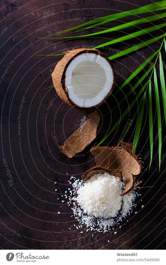 Opened coconut, coconut husk and pile of coconut flakes brown tropical Tropical Climate ingredient ingredients Christmas bakery hollow opened Brown Background