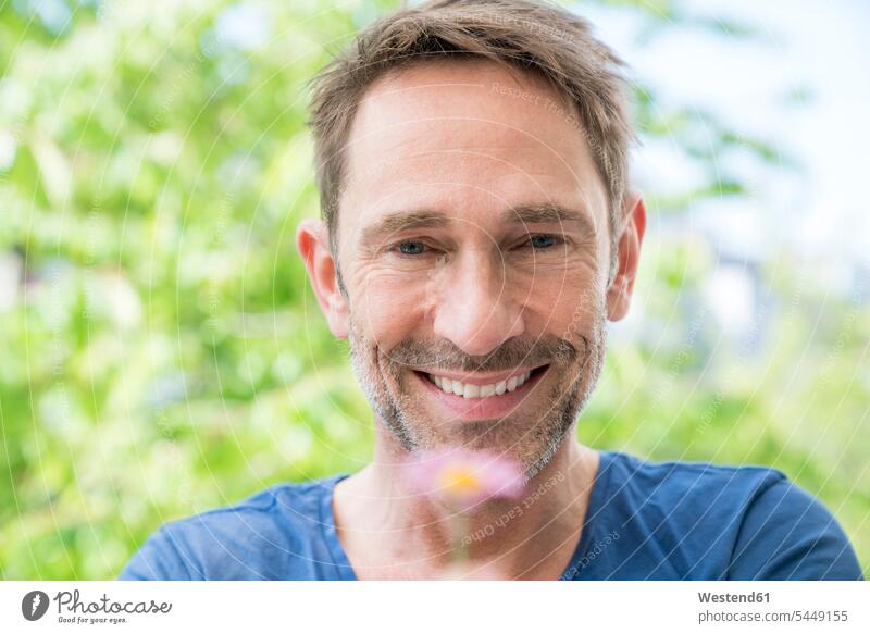 Portrait of smiling mature man with flower men males portrait portraits Adults grown-ups grownups adult people persons human being humans human beings smile