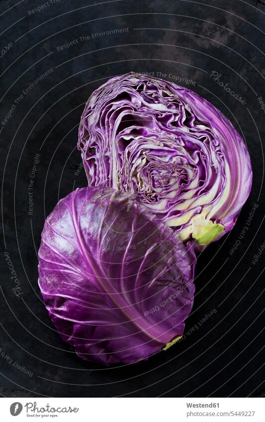 Two halves of purple Sweetheart Cabbage on dark ground Pointed Cabbage Freshness fresh healthy eating nutrition vitamines uncooked raw half halved sliced