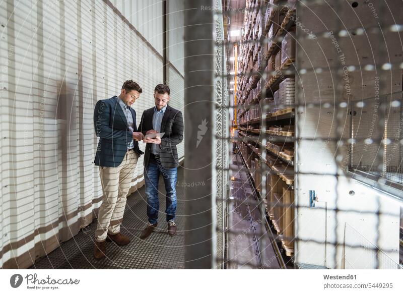 Two men in automatized high rack warehouse looking at tablet talking speaking digitizer Tablet Computer Tablet PC Tablet Computers iPad Digital Tablet