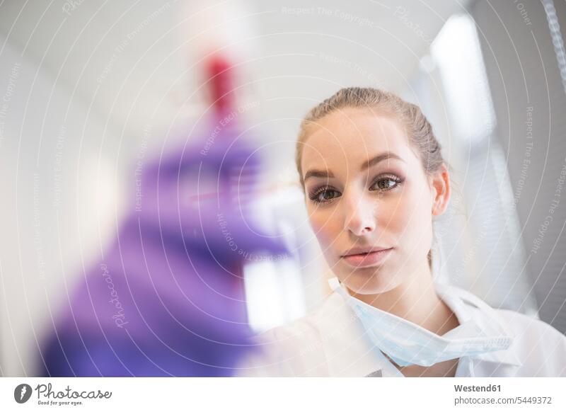 Scientist in lab examining blood sample laboratory female scientists swatch Swatches Samples looking view seeing viewing checking examine medical sample