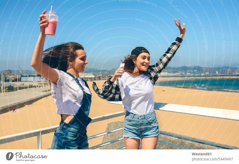 Young woman dancing and having fun on roof terrace dance female friends mate friendship happiness happy deck rooftop females women Adults grown-ups grownups