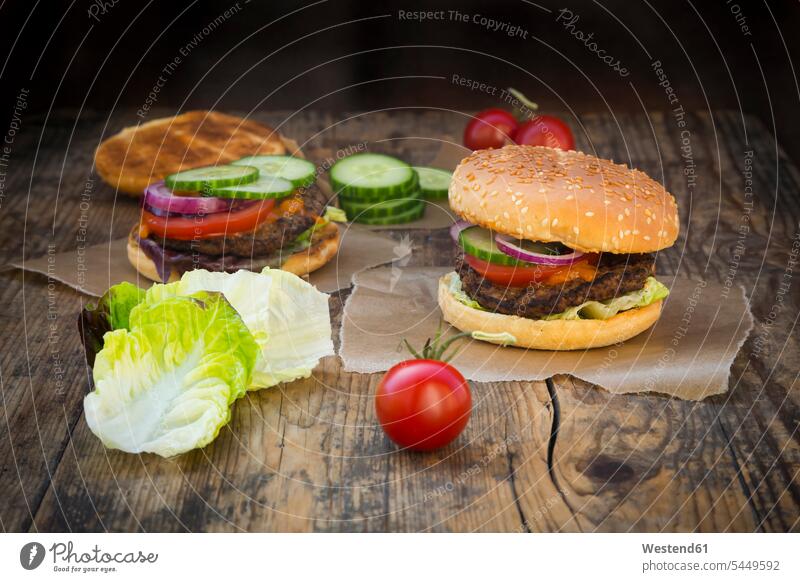 Homemade burger red onion red onions garnished Burger Tomato Tomatoes lettuce leaf lettuce leaves sliced Unhealthy Eating unhealthy sesame seed bun