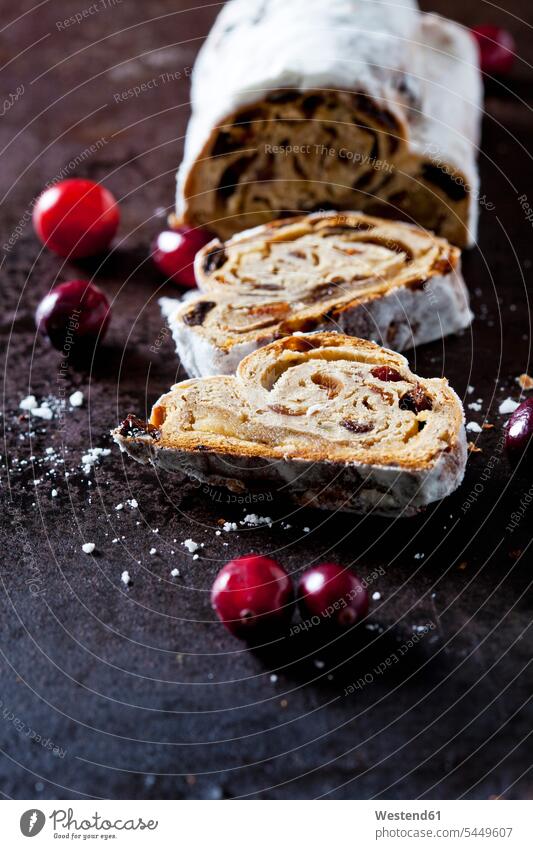 Sliced Christmas Stollen with icing sugar baking bake cut Christmas pastry Christstollen three objects 3 sliced powdered sugar Slices elevated view