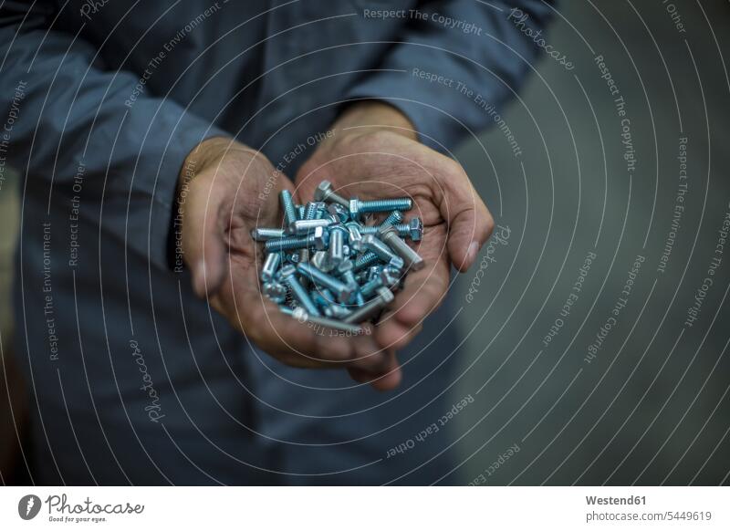 Close-up of hands holding screws working At Work man men males worker blue collar worker workers blue-collar worker Adults grown-ups grownups adult people