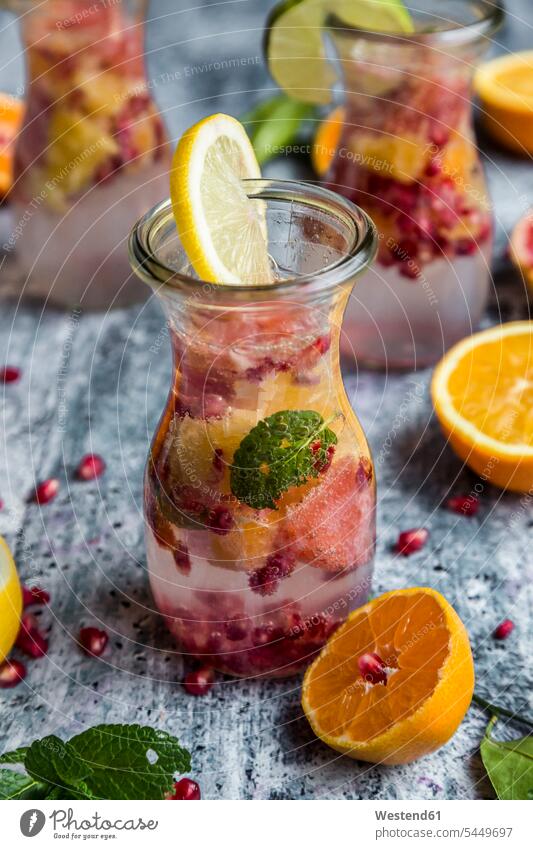 Detox water, glass of infused water with citrus fruits, pomegranate seed and mint Glass Glasses Pomegranate Pomegranates focus on foreground