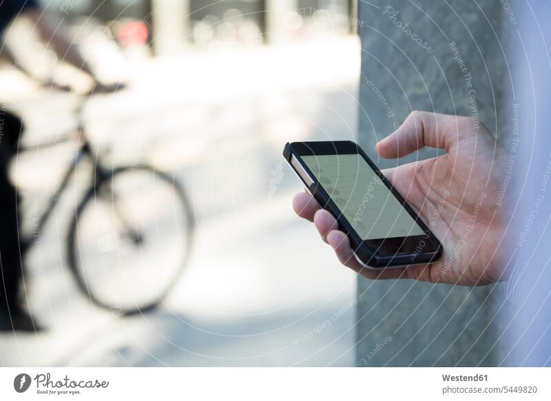 Close-up of businessman holding cell phone mobile phone mobiles mobile phones Cellphone cell phones Businessman Business man Businessmen Business men telephones