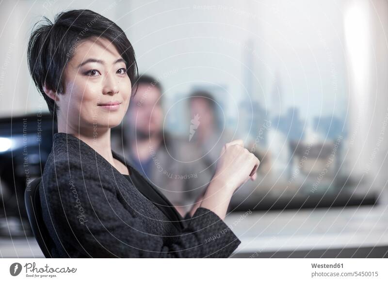 Portrait of confident woman in office females women businesswoman businesswomen business woman business women offices office room office rooms smiling smile