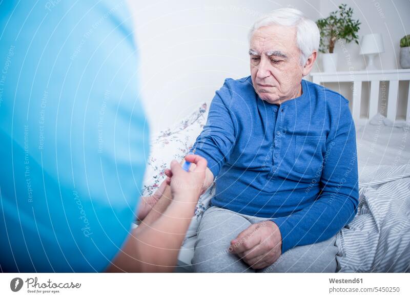 Gereatric nurse giving patient an injection assistance Looking After support care illness disease Sickness illnesses diseases elderly care geriatric care