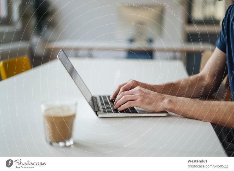 Close-up of man using laptop in office Laptop Computers laptops notebook Businessman Business man Businessmen Business men typing type hand human hand hands