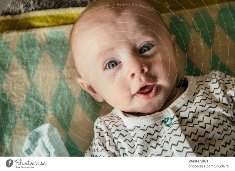 Happy baby face as seen from above portrait portraits infants nurselings babies lying laying down lie lying down people persons human being humans human beings