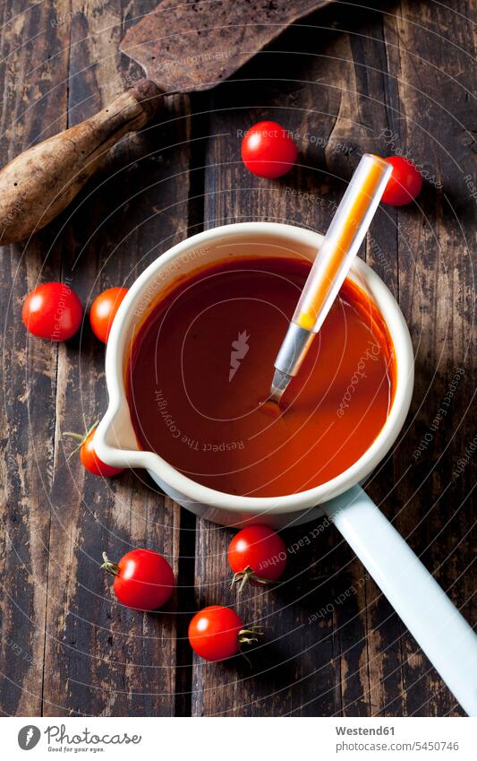 Casserolle with tomato soup Spoon Spoons dark wood red rustic close-up close up closeups close ups close-ups preparing Food Preparation preparing food wooden