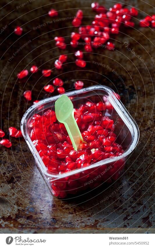 Pomegranate seed and plastic spoon in plastic box food and drink Nutrition Alimentation Food and Drinks Pomegranates focus on foreground Focus In The Foreground