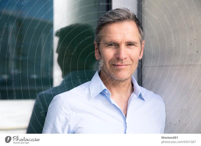 Portrait of confident mature businessman at a glass front Businessman Business man Businessmen Business men confidence portrait portraits smiling smile