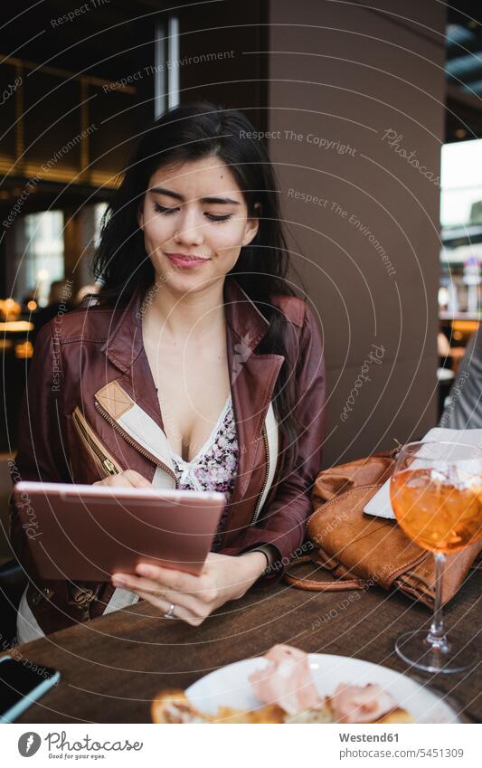 Woman using tablet in a bar digitizer Tablet Computer Tablet PC Tablet Computers iPad Digital Tablet digital tablets woman females women computer computers