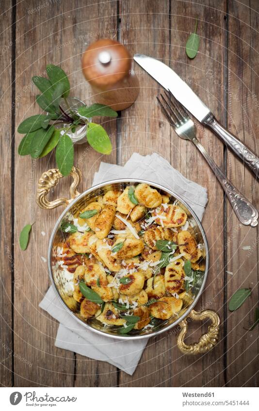 Homemade gnocchi with sage butter and parmesan Glass Glasses napkin napkins cloth napkin cloth napkins pepper grinder pepper mill prepared Parmesan Cheese