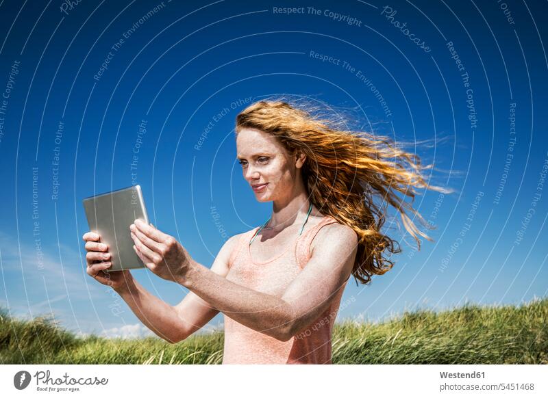 Netherlands, Zandvoort, woman standing in dunes with tablet sand dune sand dunes digitizer Tablet Computer Tablet PC Tablet Computers iPad Digital Tablet