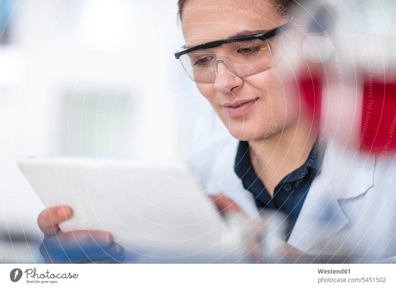 Scientist working in lab looking at tablet test testing laboratory female scientists At Work digitizer Tablet Computer Tablet PC Tablet Computers iPad